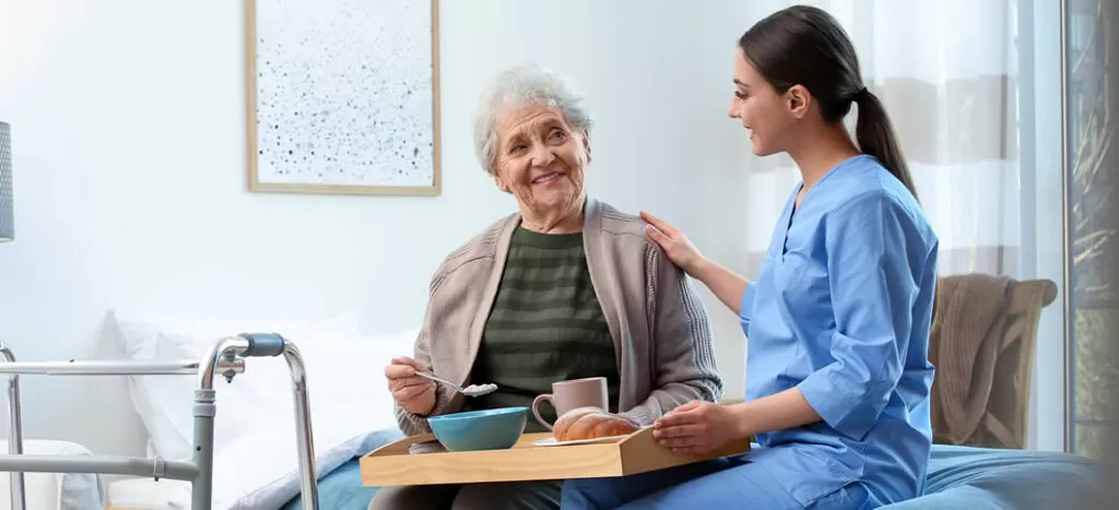 A woman sitting next to an older person.