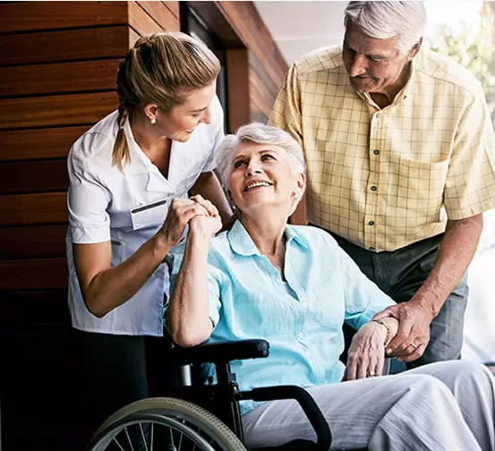 A woman in a wheelchair with two men.