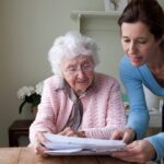 A caregiver showing documents to the senior