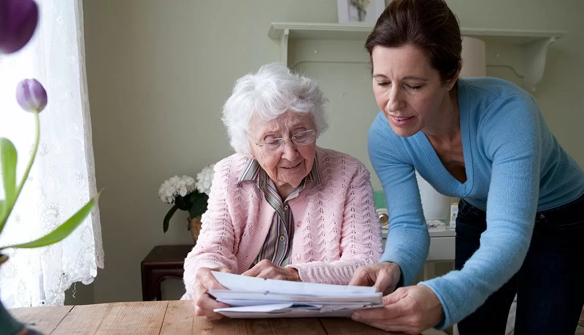 A caregiver showing documents to the senior