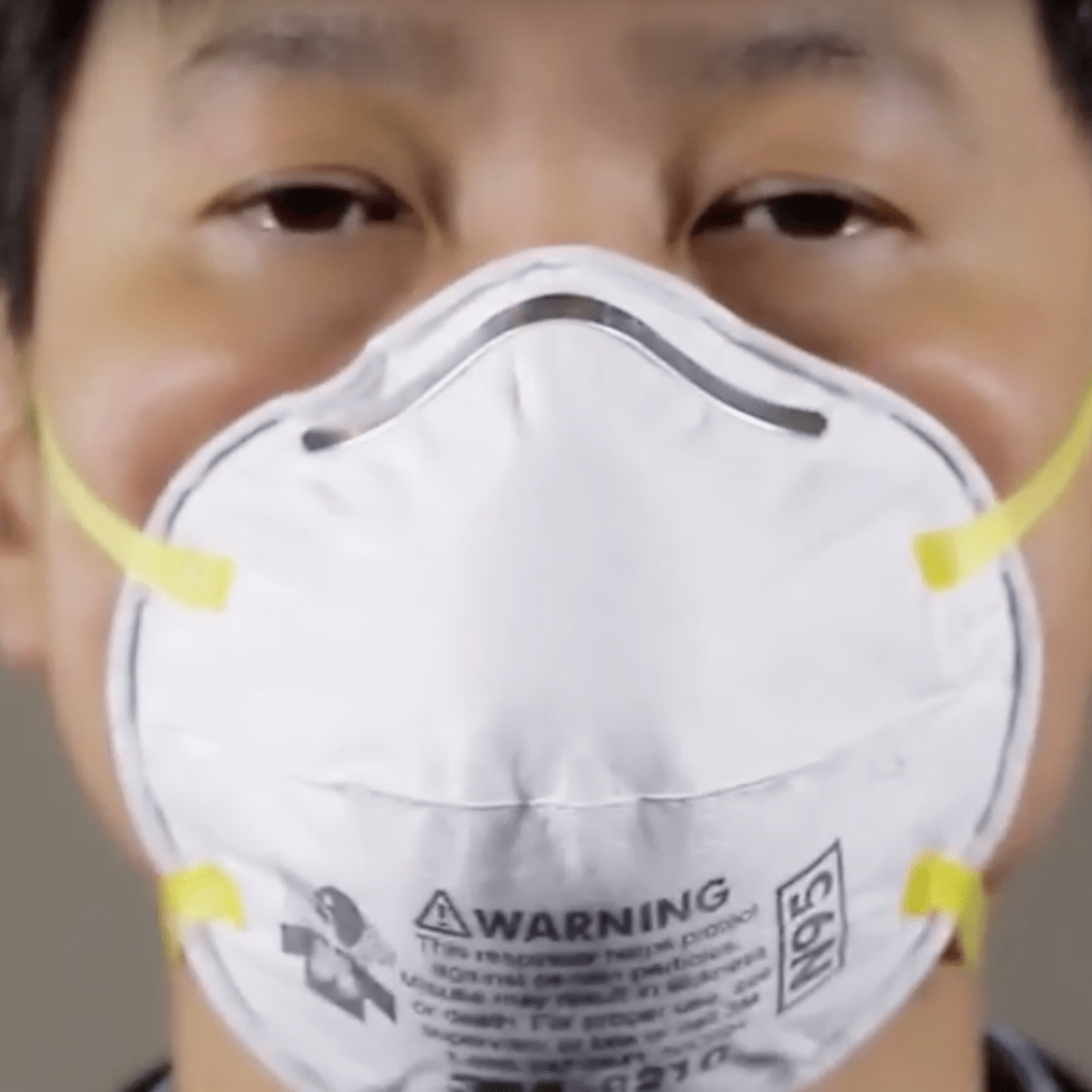 A man covering his mouth and nose with N95 Mask