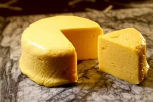 A piece of cheese sitting on top of a table.