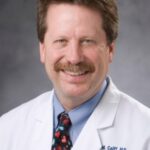 Doctor Robert Califf in white color coat and colorful tie