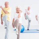 Senior couples doing cardio exercises on the yoga mat