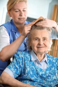 cargiver brushing senior lady's hair - carmel ca in home personal care