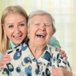 cargiver and senior laughing - pebble beach in home caregiving