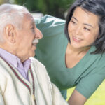 caregiver smiling at senior man - Pebble Beach companion care services