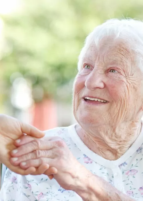 An older woman holding her hand out to someone