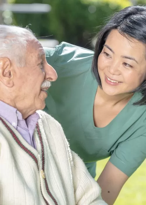 A woman is helping an old man