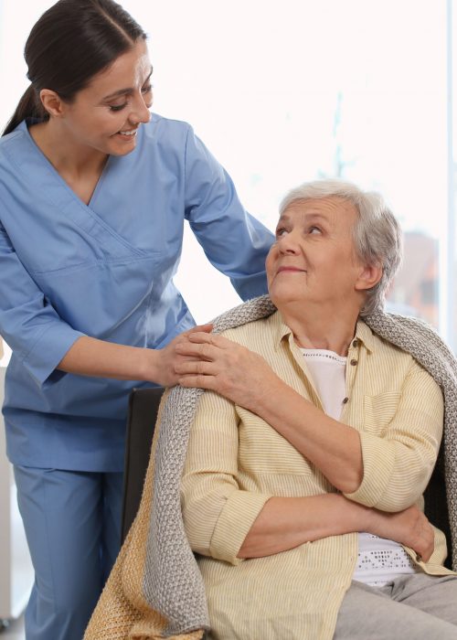 55+ lady smiling touching caregivers hand - Monterey Home Personal Care